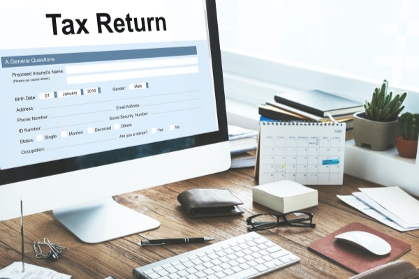 computer on desk showing tax return form