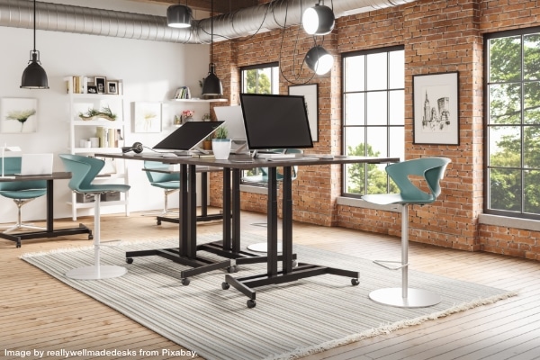 Several standing desks clustered in an open office