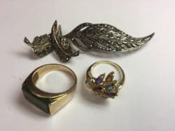 2 gold rings and one gold brooch