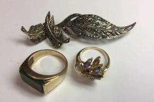 2 gold rings and one gold brooch