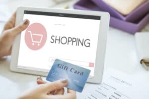 person shopping online with gift cards
