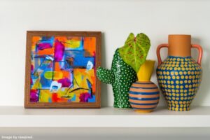 framed print and vases on a shelf representing items you should wait to purchase when you move