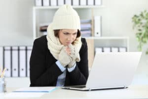 woman dressed warmly in cold office