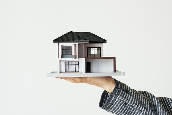 model of house in palm of hand for downsizers