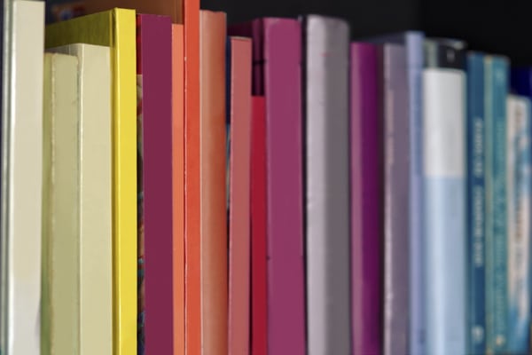 books on a shelf sorted in rainbow colours