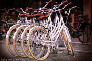 white bicycles lined up on street
