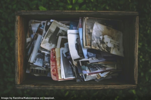 box of old photographs representing downsizing memorabilia