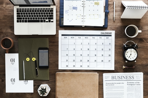 personal productivity tools - computer, calendar, planner, phone, watch on desktop