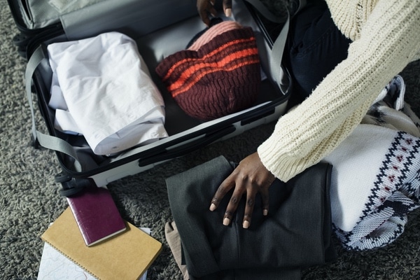 person preparing to pack suitcase for a move