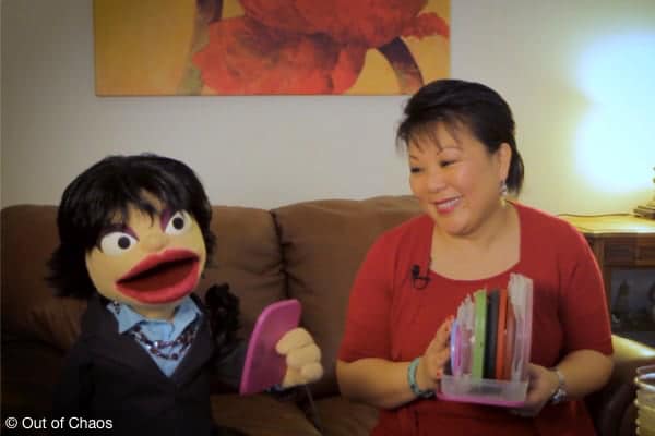 Linda and Lil' Chu on couch demonstrating how to organize food storage containers