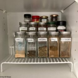 3-tier mini shelf holding labelled organized spice bottles