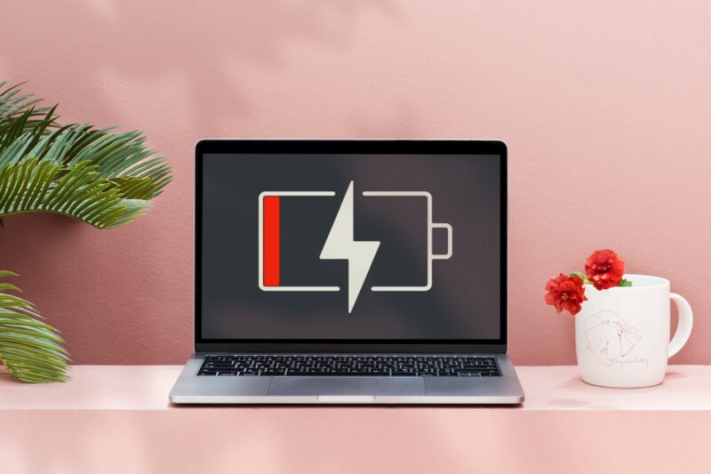 laptop computer displaying large charging icon representing owning more stuff saves time