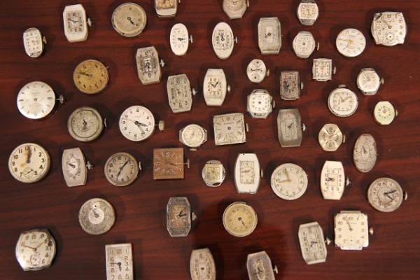 vintage wristwatches on table representing downsizing your collection