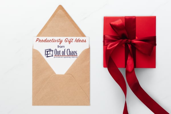 card with Out of Chaos logo sticking out of it beside box with red wrapping paper signifying productivity gift ideas