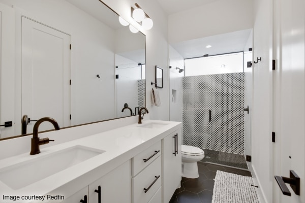white bathroom cabinets with glass shower doors in background for Redfin article