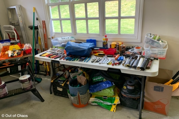 hardware and garden tools arranged on table in garage showing categorizing portion of estate clearing proceess