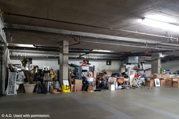 parking garage at strata/condo filled with household items preparing for a decluttering party