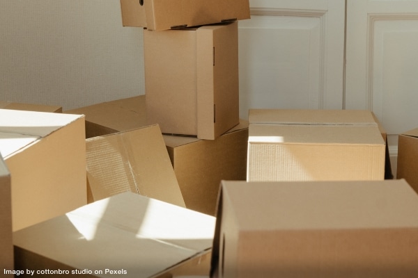 Various sizes and types of moving boxes scattered across a room.