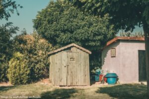garden shed beside garage on well-kept property representing declutter your outdoor space