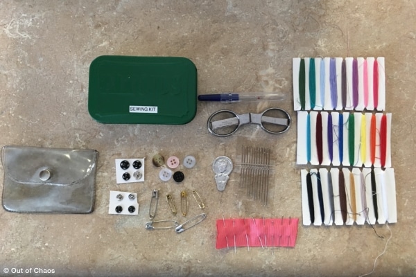 A travel mending kit made with supplies from home and stored in a painted Altoids container