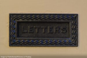 decorative letter slot in doorway representing treating email like postal mail