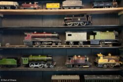 model trains lined up on a shelving unit